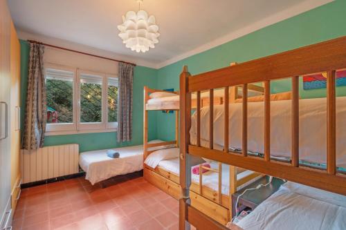 a bedroom with two bunk beds and a chandelier at Tordera Village in Tordera