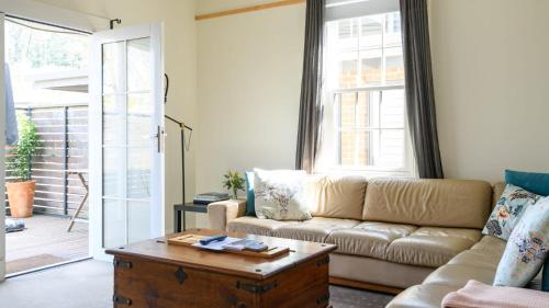 a living room with a couch and a coffee table at Heritage Cottage Daylesford in Daylesford