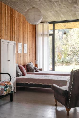 a large bed in a room with a large window at Proste Chwile in Tylicz
