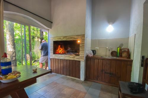 Ein Mann steht in einer Küche mit Kamin in der Unterkunft La Unión in Mar Azul