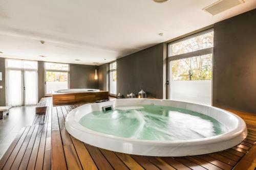 a large bath tub in a room with wooden floors at Quartier Puerto Urbano in Buenos Aires