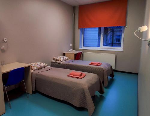 a room with two beds and a window at Tallinn Airport Stay in Tallinn