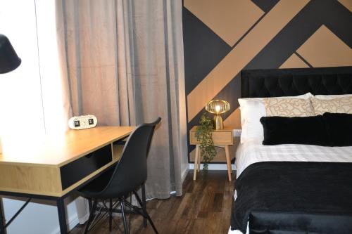 a bedroom with a desk and a bed and a desk and chairs at Coventry Studio in Parkside