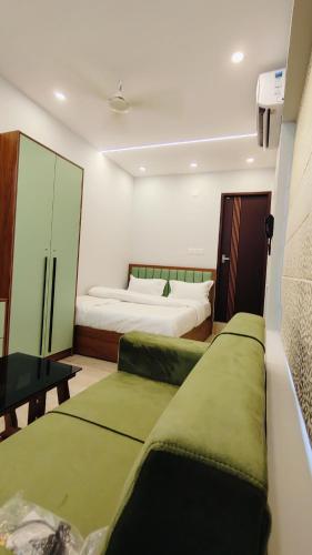 a bedroom with two beds with green pillows at Oasia Resort in Kannur