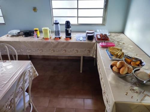 a room with two tables with food on it at Pousada Rezende in Caldas Novas