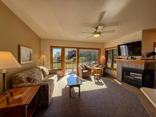 a living room with a couch and a fireplace at Poplar River Condos in Lutsen