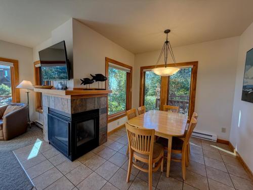 a dining room with a table and a fireplace at Poplar River Condos in Lutsen