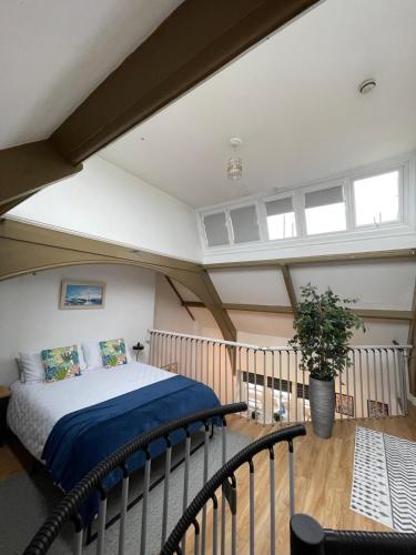 a bedroom with a bed in a attic at The Loft St Austell in St Austell