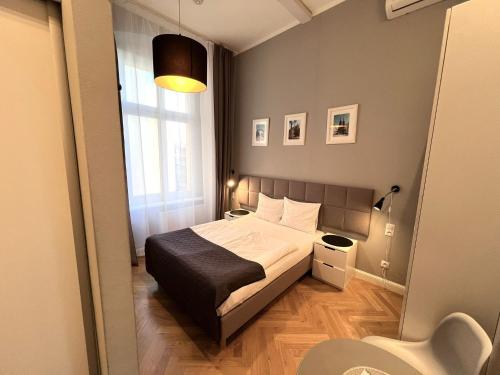 a small bedroom with a bed and a window at Wroclaw City Apartments in Wrocław