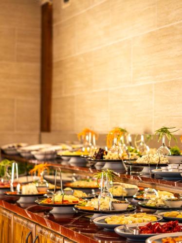 a buffet line with many plates of food at Cappadocia ByHan Hotel - Special Class in Uchisar