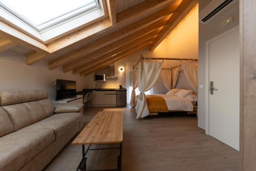 a living room with a couch and a bed at Alojamientos La Antigua in Molina de Aragón