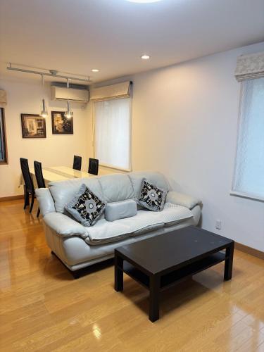 a living room with a couch and a table at Aki House居住型民泊小岩駅まで送迎あり in Tokyo
