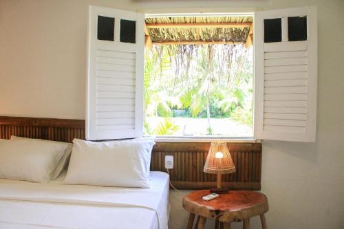 Ένα ή περισσότερα κρεβάτια σε δωμάτιο στο MHV Milagres - Casa Aruã, Luxo, Conforto e Privacidade a 60 metros da Exclusiva Praia do Marceneiro