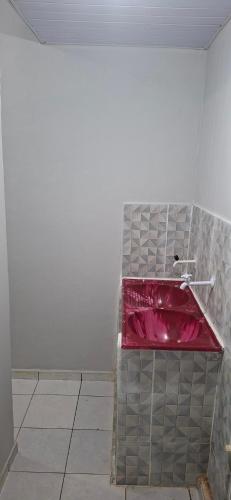 a bathroom with a red counter top in a room at Apartamento in Belém