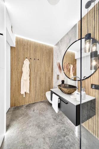 a bathroom with a sink and a mirror at Sense Resort - Luxury Glamping in Maruszyna