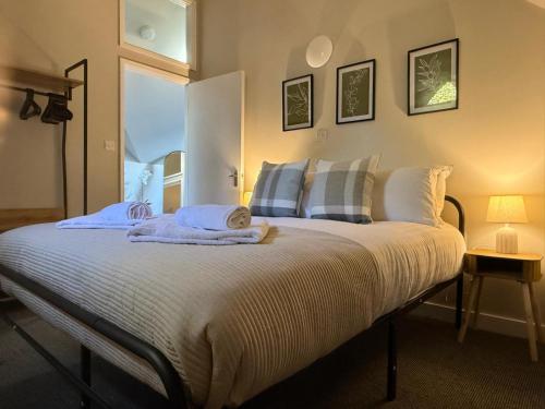 a bedroom with a bed with towels on it at 4 School Path in Ironbridge