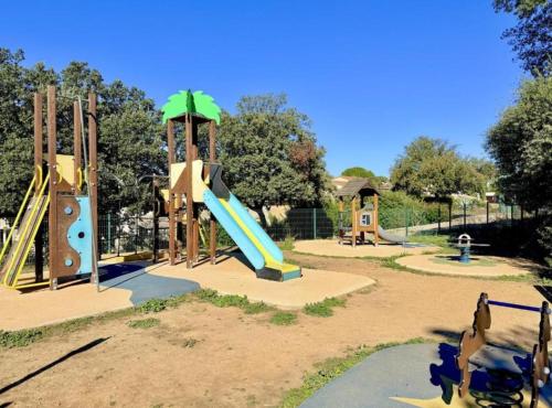 a playground with a slide in a park at Harmonie in Calvisson