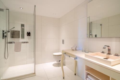 a white bathroom with a sink and a shower at Hotel Palma Avenidas in Palma de Mallorca