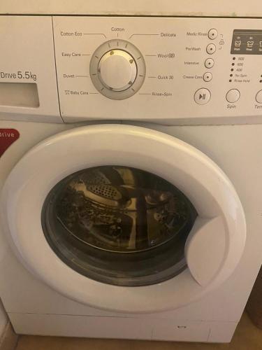a close up of a washing machine with its door open at 2 Bedroom Subhadra Bhavan in mayapur
