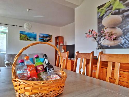 a basket of drinks on a dining room table at Skyline Home Funchal in Funchal
