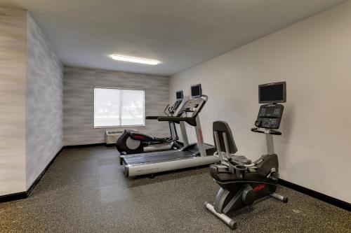 a gym with two exercise bikes and a treadmill at Best Western Plus Las Colinas Inn & Suites in Irving