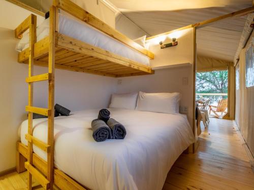 a bedroom with a bunk bed with two teddy bears on it at AfriCamps Hoedspruit in Hoedspruit