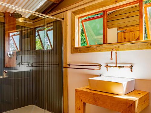 a bathroom with a sink and a shower at AfriCamps Hoedspruit in Hoedspruit