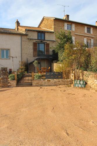 a house with a dirt yard in front of it at La Bauderie in Bussières