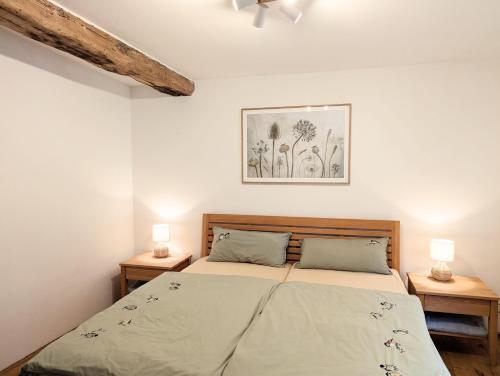a bedroom with a bed with two night stands at Ferienhaus am Gässchen in Edesheim