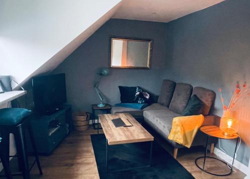 a living room with a couch and a table at Foundry Street Apartment 2 - Dunfermline city centre in Dunfermline