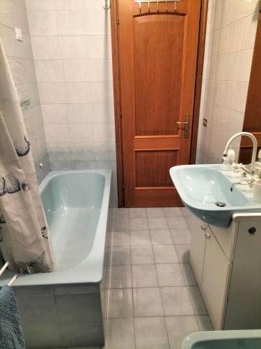 a bathroom with a bath tub and a sink at Locazione turistica Gisella 