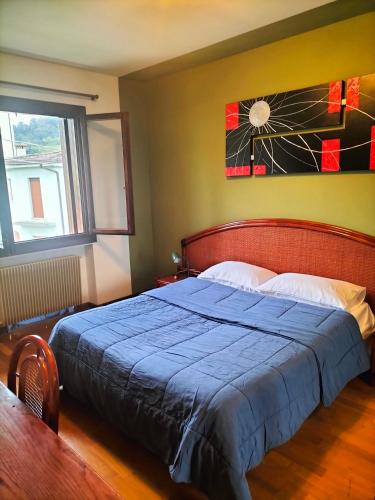 a bedroom with a bed with a blue blanket at Locazione turistica Gisella 