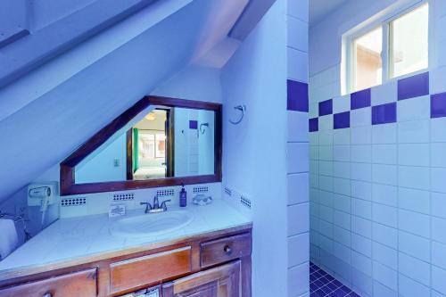 a bathroom with a sink and a mirror at Palm @ Caribe Island in San Pedro