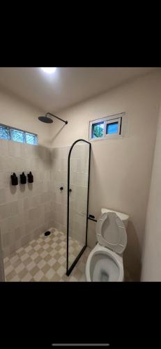 a bathroom with a shower and a toilet at PointBreak Surfhouse in Puerto Escondido
