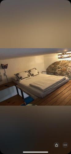 a bed in a room next to at La Adornada Orquidea in Taxco de Alarcón