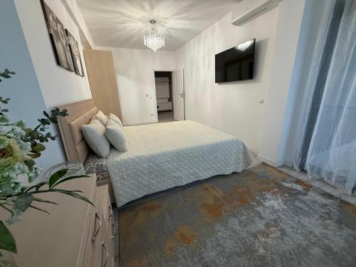 a bedroom with a bed and a television in it at Premium Apartment in Craiova