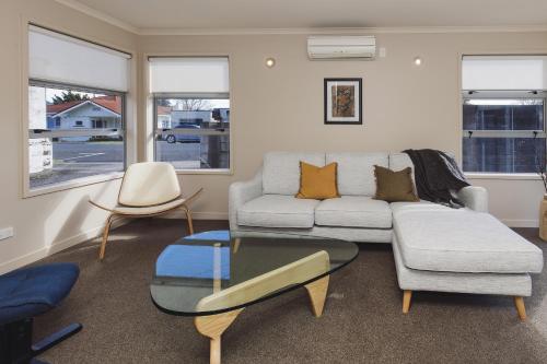 a living room with a couch and a glass table at City Sails - 3 BR townhouse in central New Plymouth in New Plymouth