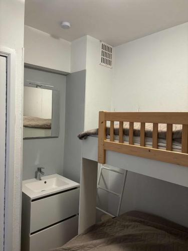 a bedroom with a bed and a sink and a bunk bed at Monte-Carlo in Koksijde