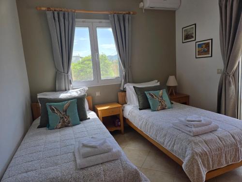 En eller flere senge i et værelse på Olive Garden Villa