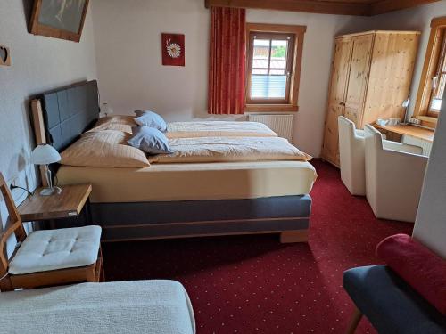 a hotel room with two beds and a window at Seilhof in Ennsling