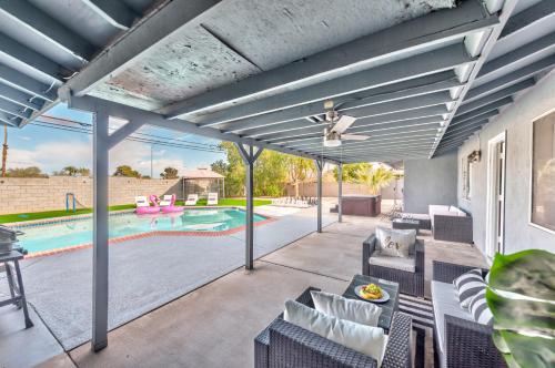 an outdoor patio with chairs and a swimming pool at Vila Hearts in Las Vegas