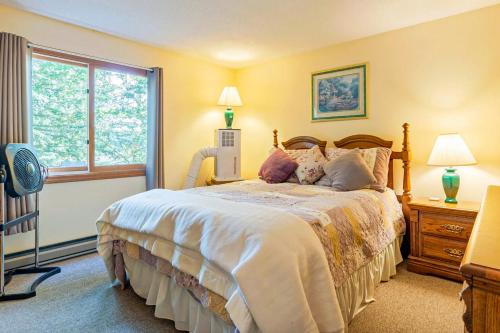 a bedroom with a large bed and a window at Moose’in Around in Sweden