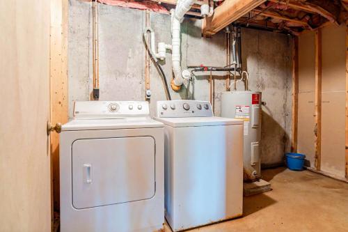a laundry room with a washer and dryer at Moose’in Around in Sweden