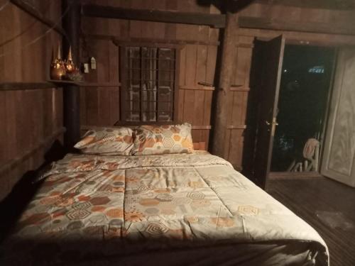 Sconvolt Homestay في كراتي: غرفة نوم بها سرير في غرفة بها نافذة