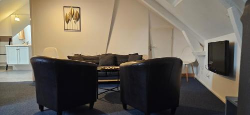 a living room with a couch and a tv at hotel terminus auray in Auray