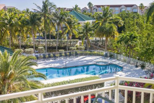 an overhead view of a swimming pool on a balcony with palm trees at Tortuga Suite at Sunrise Suites Resort - Heated Pool, Hot Tub & Free Parking in Key West