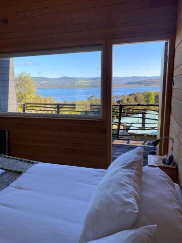 a bedroom with a bed and a window with a view at Huillín Lodge in Huillinco