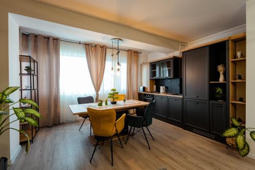 Una cocina y un comedor con mesa y sillas. en Ivory Garden Retreat by Blvd 60B2 - Luxury Apartment in Voluntari, en Voluntari