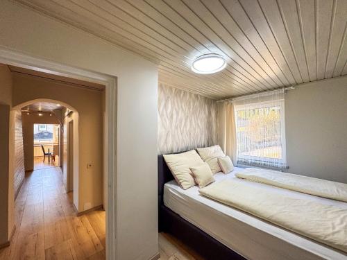 a bedroom with a large bed with a ceiling at White Pearl Apartment in Murau