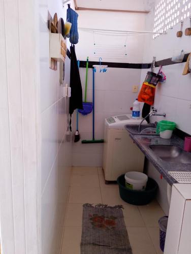 a small kitchen with a sink and a counter at Lar caprichoso in Aracaju